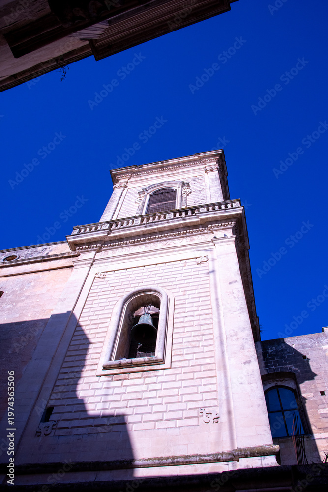 Obraz premium The majestic bell tower of Lecce Cathedral, in siuthern Italy, rising above the Baroque skyline of the historic city. 