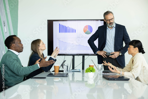 Картината върху платно Diverse business team having a tense meeting, discussing market analysis and sal