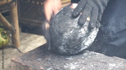 Wallpaper Mural Manual activity of opening roasted coconut shell as part of preparing a natural healthy drink. Torontodigital.ca