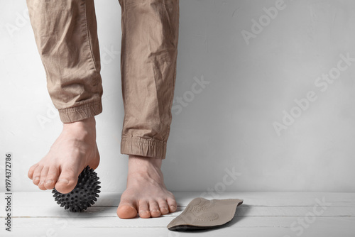 Front view of foot correction with orthopedic insole and massage ball