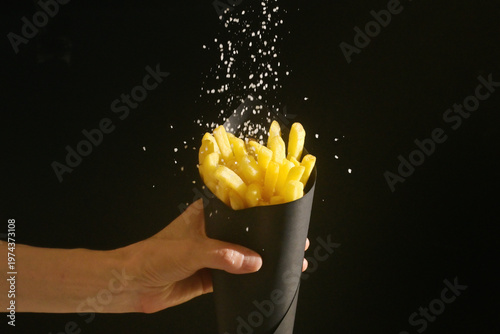 Close-up shot of tasty french fries in black box