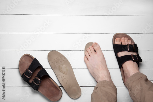 Top view of legs using orthopedic insole and corrective slipper with copy space