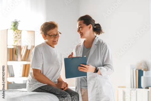 Friendly Female Doctor Consulting Senior Patient in Modern Medic