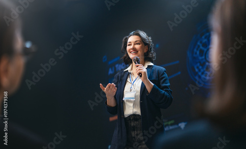 Confident Businesswoman Speaking at Technology Conference, Inspiring Audience