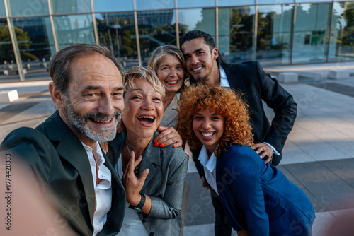 Slika na platnu Diverse business team taking happy selfie outdoors