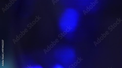 Colorful lights shine in different frames with varying colors and patterns in a simple display during evening hours