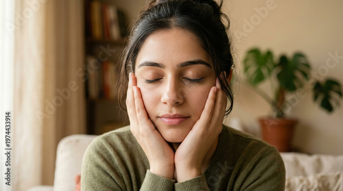 Close-up of calm woman resting face in hands, relaxed expression, self-care, peace and mindfulness concept.