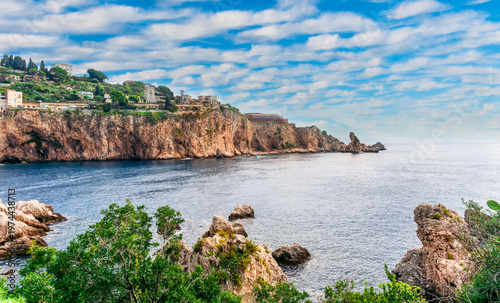 beautiful landscape of famous italiat resort Portofino in Luguria with ancient houses and buildings of hotels and restaulants along the embarkment of a sea gulf with sunset golden light