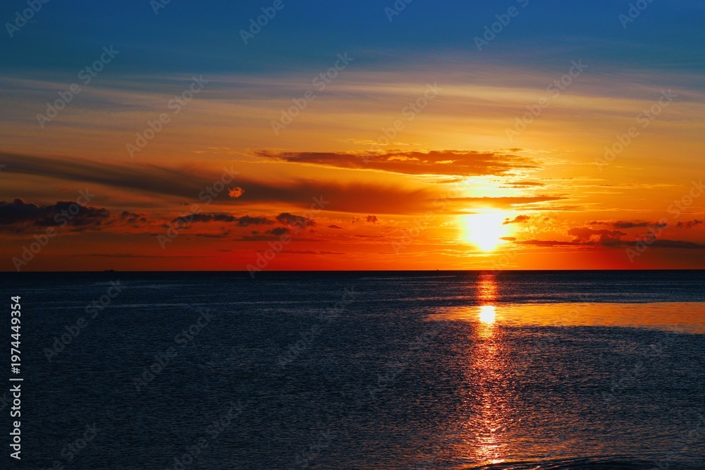 Fototapeta premium Sunset over the Waters of Manado Bay
