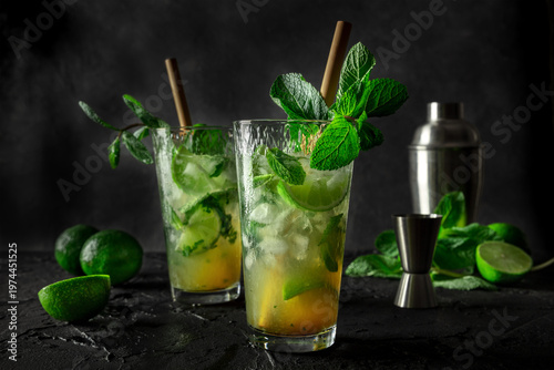 Mojito, summer cocktail with mint, lime, and ice, side view of two glasses