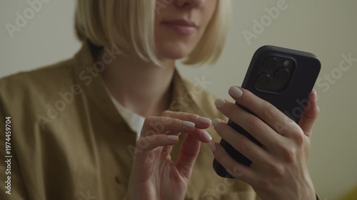 Woman using smartphone in soft indoor light