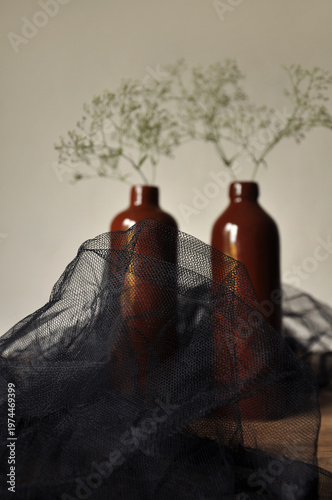 Dark floral abstraction, modern interior. Clay bottles, dried plants, minimalist modest interior vertical wallpaper. Black surrounding grid. Sustainability in lifestyle, harmony in home environment