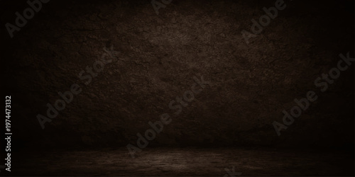 A dark aged concrete wall background with a textured gray stone pattern and a dirty vintage grunge effect on a blank empty room floor backdrop