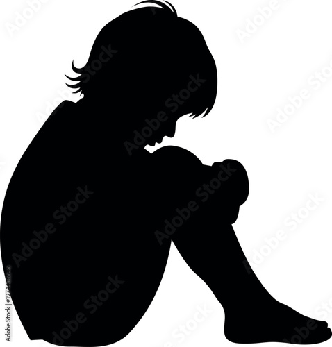 Silhouette of a young person sitting with knees drawn to chest