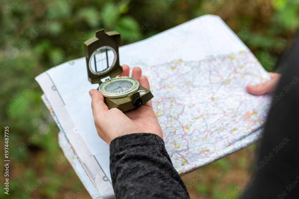 Naklejka premium Navigation outdoors with map compass