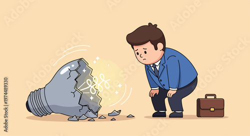 Sad businessman looking at a broken light bulb representing a failed idea or lack of inspiration