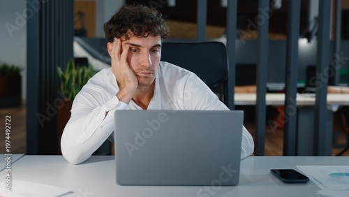 Bilde på lerret Boring sleepy tired Caucasian business man feeling bored looking in laptop unmot
