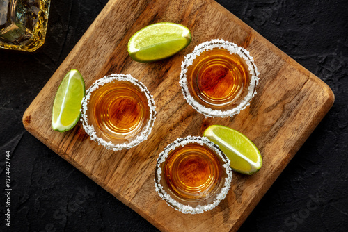 Wallpaper Mural Tequila shots with salted rims and lime slices, overhead flat lay shot on a black slate background Torontodigital.ca
