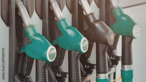 Gas pump nozzles and hoses on a wall at a fuel station