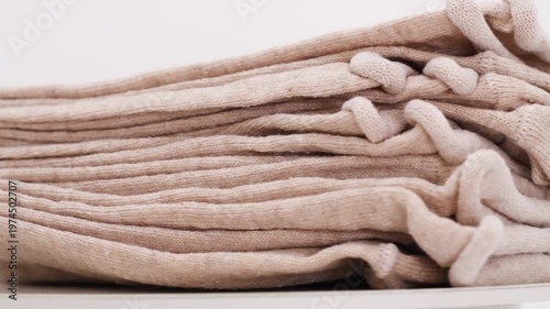 Simple process of folding beige socks in a tidy way for storage and organization in a home or workspace setting