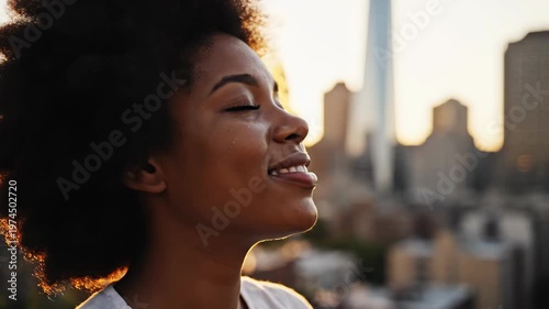Young African American Woman Enjoying Golden Hour Sunset on City Rooftop.