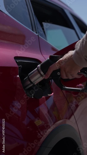 Person refueling hydrogen fuel cell car at station oil crisis, inflation