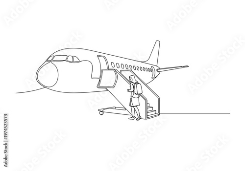 Passenger boarding airplane using stairs at airport entrance