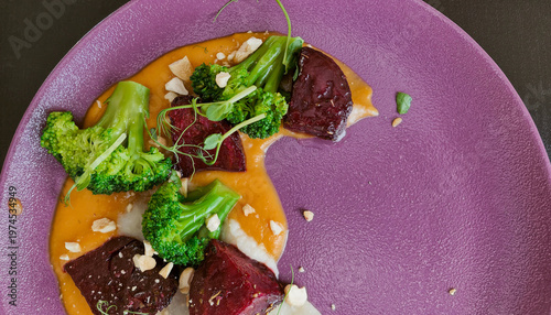 Bild auf Leinwand Top view of a gourmet dish with beetroot, broccoli, and puree on a textured purp