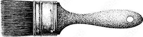 Wide paint brush with wooden handle on white studio surface