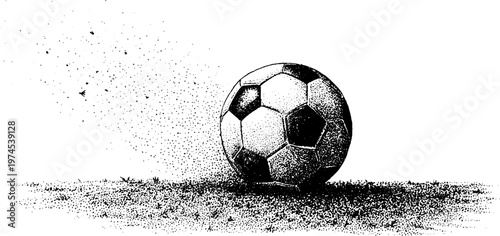 Soccer ball resting on speckled ground in studio setting