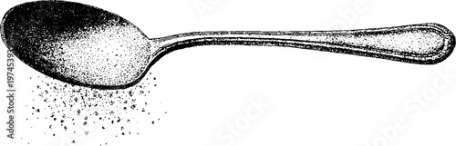 Oval spoon positioned with granules scattered on white paper