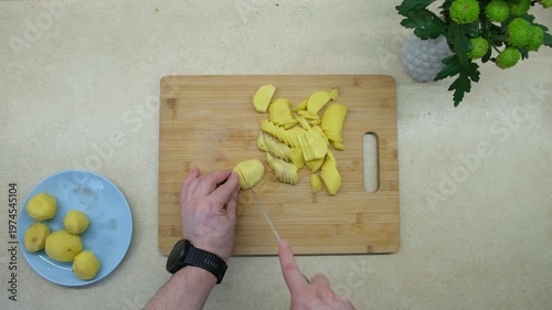 Slicing Potatoes on Wooden Cutting Board
