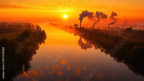 Industrial factory emissions blend with foggy river crossing at dawn with soft morning light creating an atmospheric vista