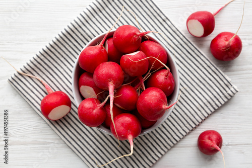 Raw Red Radishes in a Bowl, top view. Flat lay, overhead.