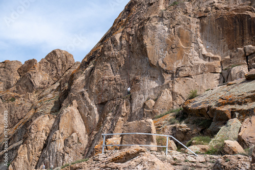 Majestic red rock formations and Buddhist petroglyphs site at Tamgaly Tas. Ili River landscape