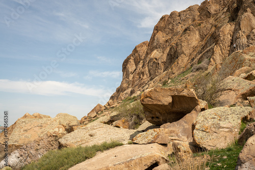 Majestic red rock formations and Buddhist petroglyphs site at Tamgaly Tas. Ili River landscape