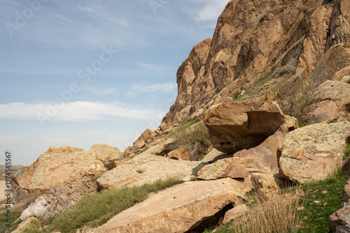 Majestic red rock formations and Buddhist petroglyphs site at Tamgaly Tas. Ili River landscape
