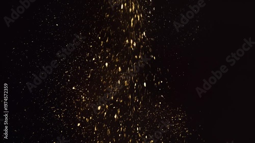 Golden particles falling down slowly.