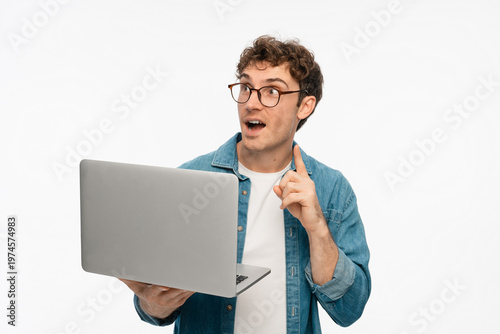 Smiling Caucasian man freelancer IT Programmer hold laptop computer pointing finger up using application, browsing sites, shopping in internet, app, reading website on white studio background