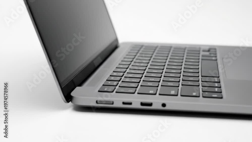 A modern 14-inch laptop with a blank display shown in a clean perspective view on a white background, detailed keyboard and sleek aluminum body, digital device ready for web and app presentation, soft