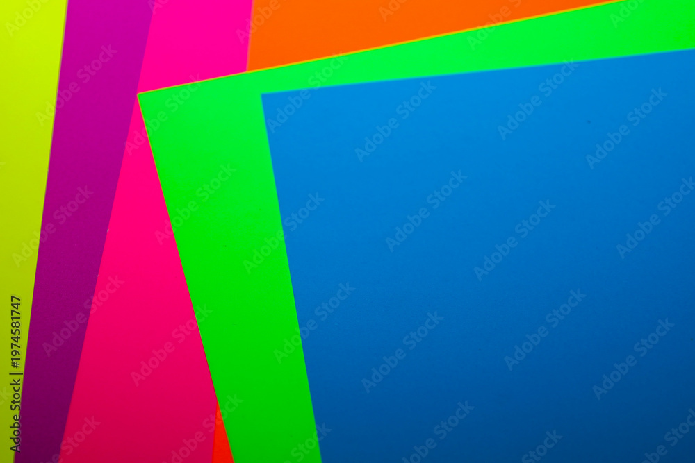 Obraz premium Multicolored sheets of paper are layered on top of each other, creating a bright multi-layered composition with sharp geometric shapes.