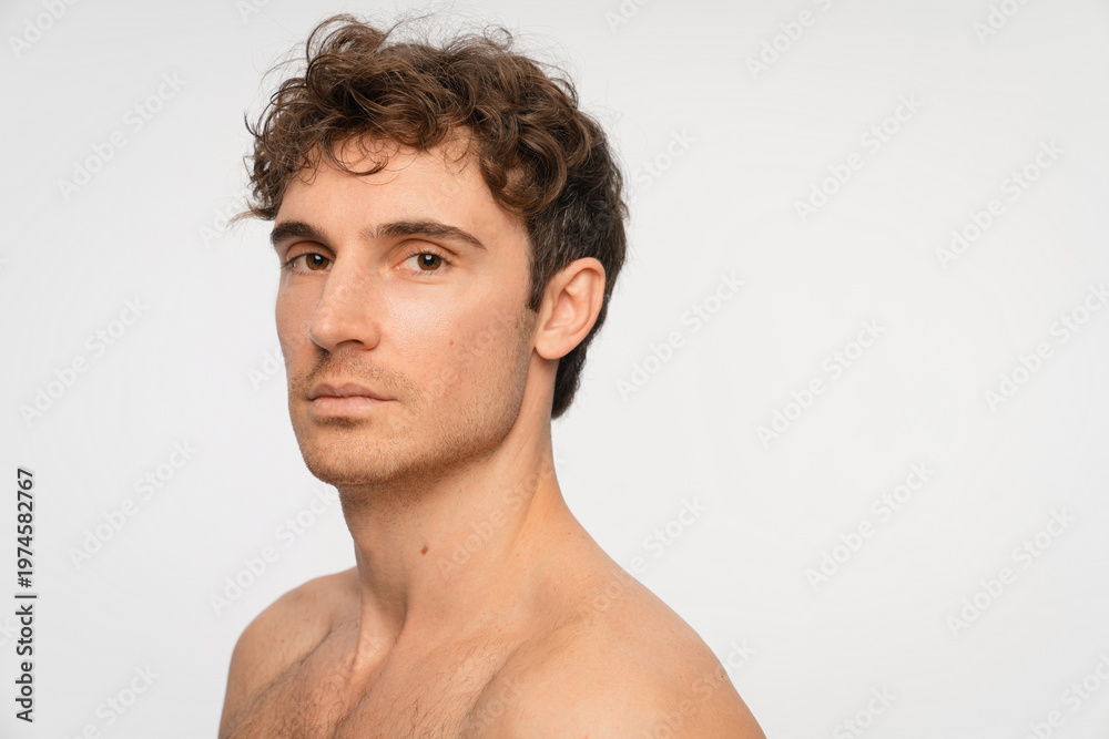 Naklejka premium Beauty, skincare and portrait of man in studio for salon, grooming dermatology. Cosmetics, glow and self care with person and facial on white background for hydration, hygiene and shine, copy space