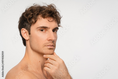 Beauty, skincare and portrait of man in studio for salon, grooming dermatology. Cosmetics, glow and self care with person and facial on white background for hydration, hygiene and shine, copy space