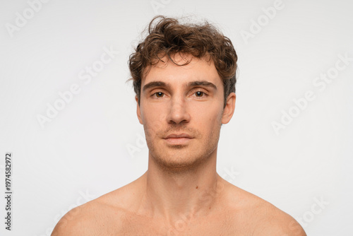 Shampoo, cosmetics and aesthetic with person on background for texture and spa treatment. Beauty, face and self care with portrait of man in studio for cleaning, salon grooming and hairstyle.
