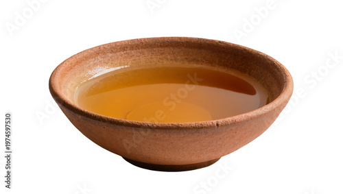 Tableau sur toile Rustic terracotta bowl filled with golden amber liquid, isolated on transparent