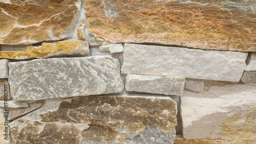 Rustic stone wall with layered natural rocks and warm tones, ideal for exterior facades, landscaping projects, and architectural visualization.