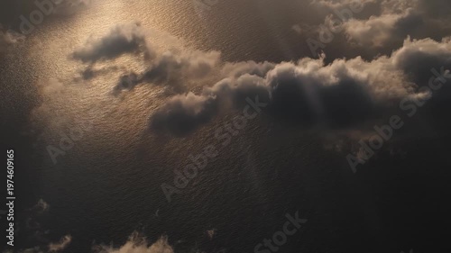 View from an airplane over the sea at dawn in the clouds. 