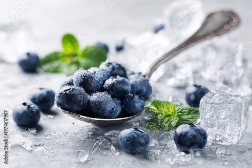 Fresh Blueberries on Spoon with Ice Cubes and Green Leaves Refreshing Healthy Concept