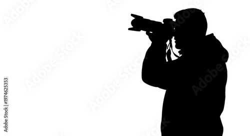Silhouette of a photographer taking a picture with a professional camera
