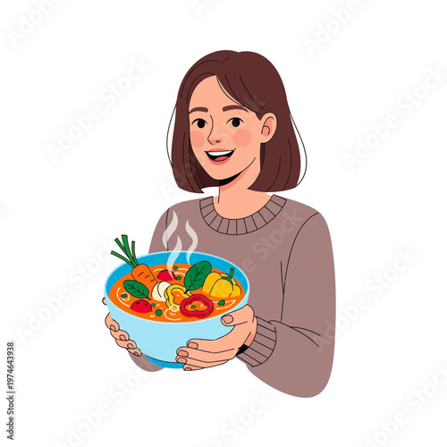 A smiling young woman with short brown hair holding a steaming bowl of colorful vegetable soup with noodles and various fresh ingredients.